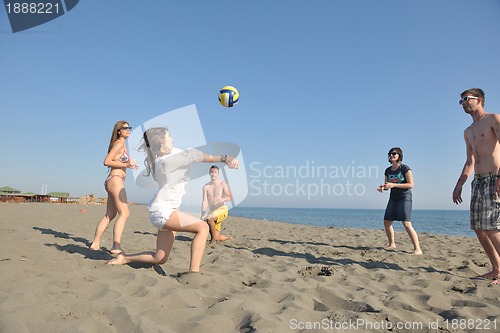 Image of young people group have fun and play beach volleyball