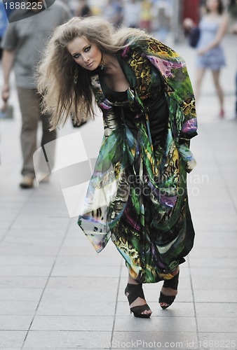 Image of elegant woman on city street at night