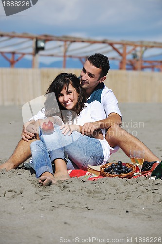 Image of young couple enjoying  picnic on the beach