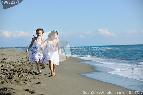 Image of cute little girls running on beach