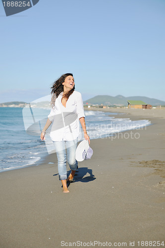 Image of happy young woman on beach