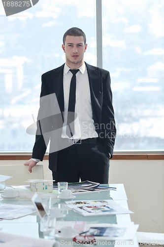 Image of young business man alone in conference room