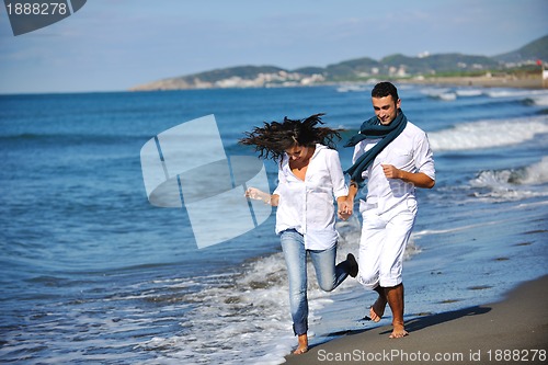Image of happy young couple have fun at beautiful beach