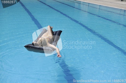 Image of beautiful woman relax on swimming pool