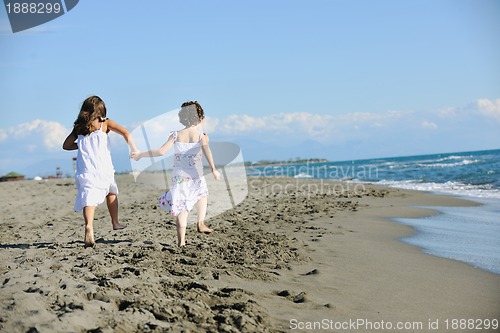 Image of cute little girls running on beach