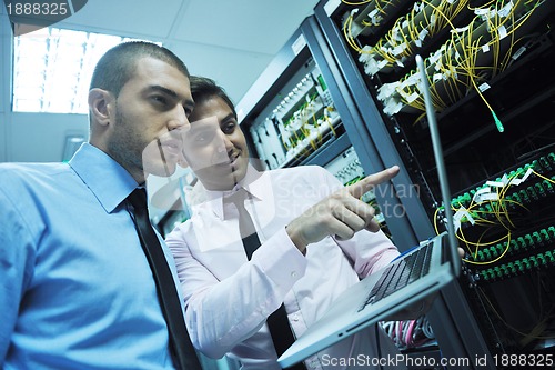 Image of it engineers in network server room