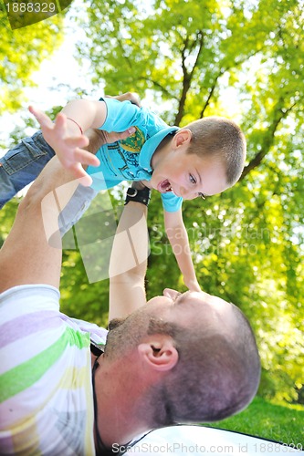 Image of happy father and son have fun at park