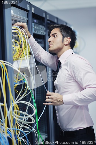 Image of young it engeneer in datacenter server room