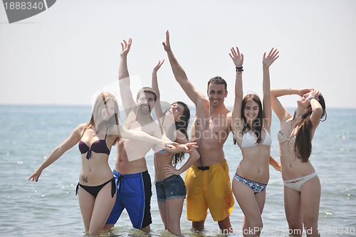 Image of happy people group have fun and running on beach