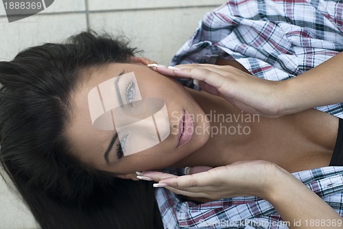 Image of beautiful young lady posing in garden
