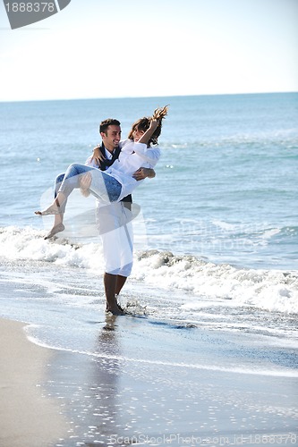 Image of happy young couple have fun at beautiful beach