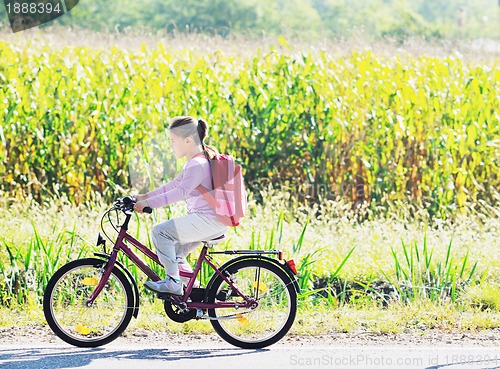 Image of schoolgirl traveling to school on bicycle