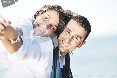 Image of happy young couple have fun at beautiful beach