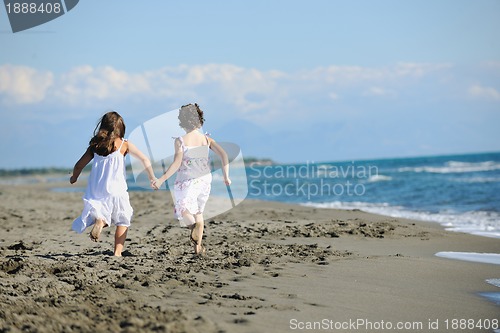 Image of cute little girls running on beach