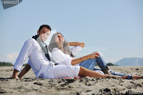 Image of young couple enjoying  picnic on the beach
