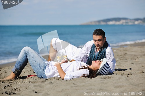 Image of young couple enjoying  picnic on the beach