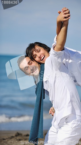 Image of happy young couple have fun at beautiful beach