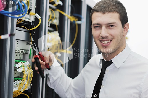 Image of young it engeneer in datacenter server room