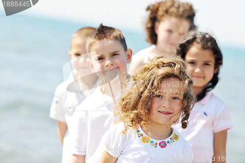 Image of happy child group playing  on beach