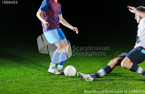 Image of football players in competition for the ball