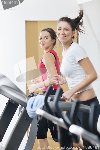 Image of woman workout  in fitness club on running track 