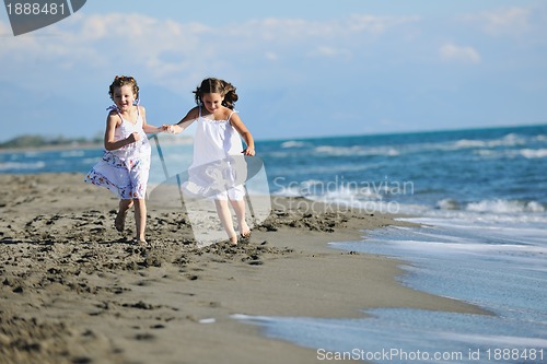 Image of cute little girls running on beach