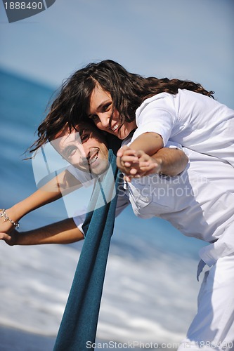 Image of happy young couple have fun at beautiful beach