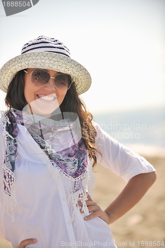 Image of happy young woman on beach