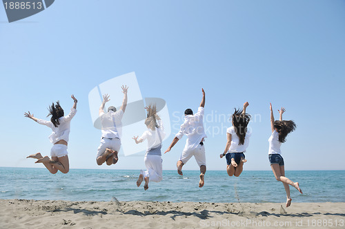 Image of happy people group have fun and running on beach
