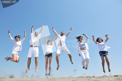 Image of happy people group have fun and running on beach