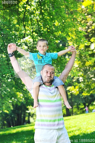 Image of happy father and son have fun at park