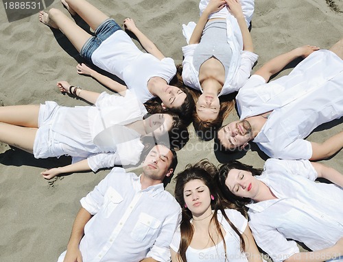 Image of Group of happy young people in have fun at beach