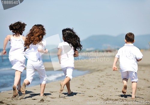 Image of happy child group playing  on beach