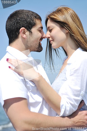 Image of happy young couple have fun on beach