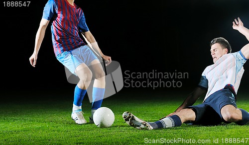 Image of football players in competition for the ball