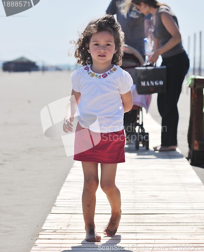 Image of little girl have fun on the beach