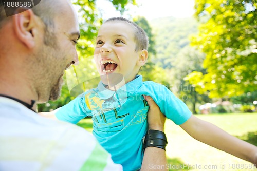 Image of happy father and son have fun at park