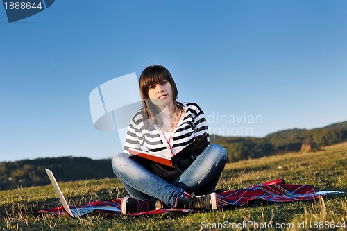 Image of young teen girl work on laptop outdoor