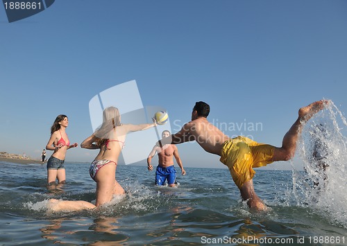 Image of young people group have fun and play beach volleyball