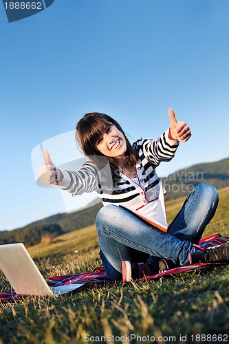 Image of young teen girl work on laptop outdoor