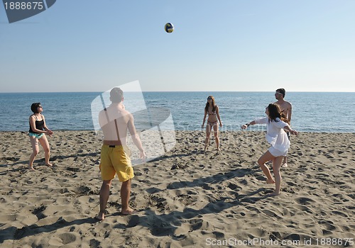 Image of young people group have fun and play beach volleyball