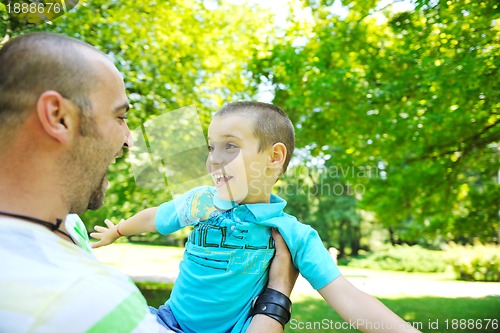 Image of happy father and son have fun at park