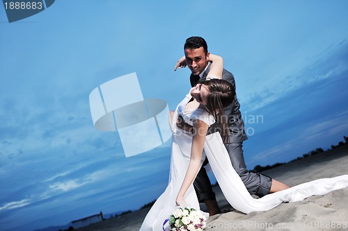 Image of romantic beach wedding at sunset
