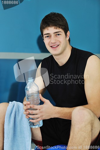 Image of man drink water at fitness workout 