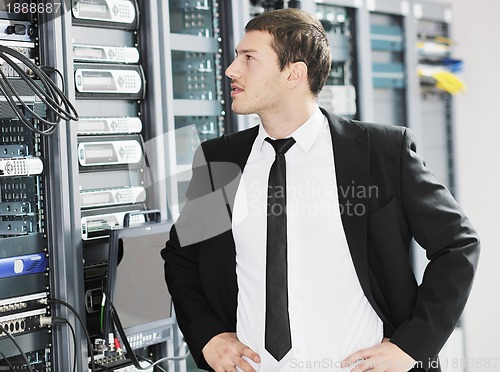 Image of young it engeneer in datacenter server room