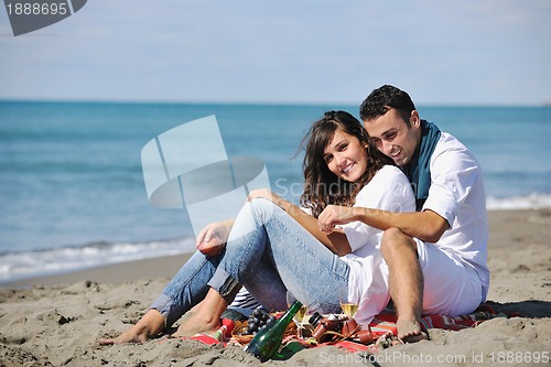 Image of young couple enjoying  picnic on the beach