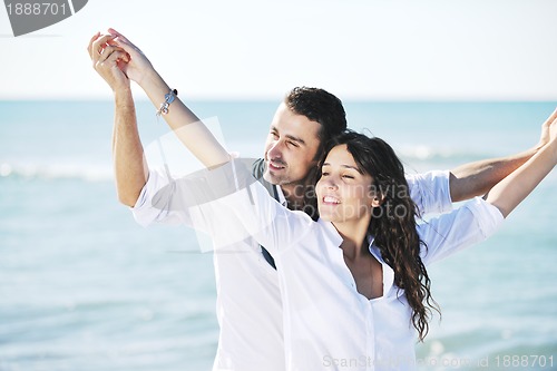 Image of happy young couple have fun at beautiful beach