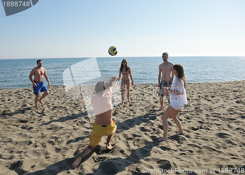 Image of young people group have fun and play beach volleyball