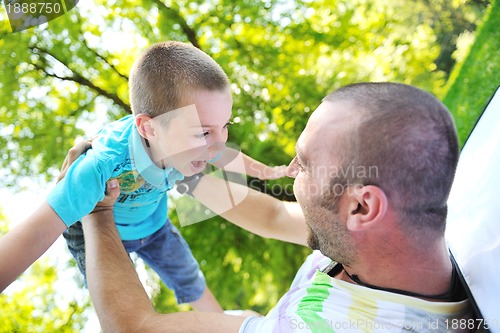 Image of happy father and son have fun at park