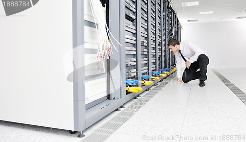 Image of young it engeneer in datacenter server room